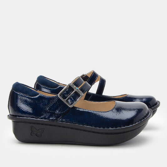 Navy blue shoes with a strap and buckle on a light gray background