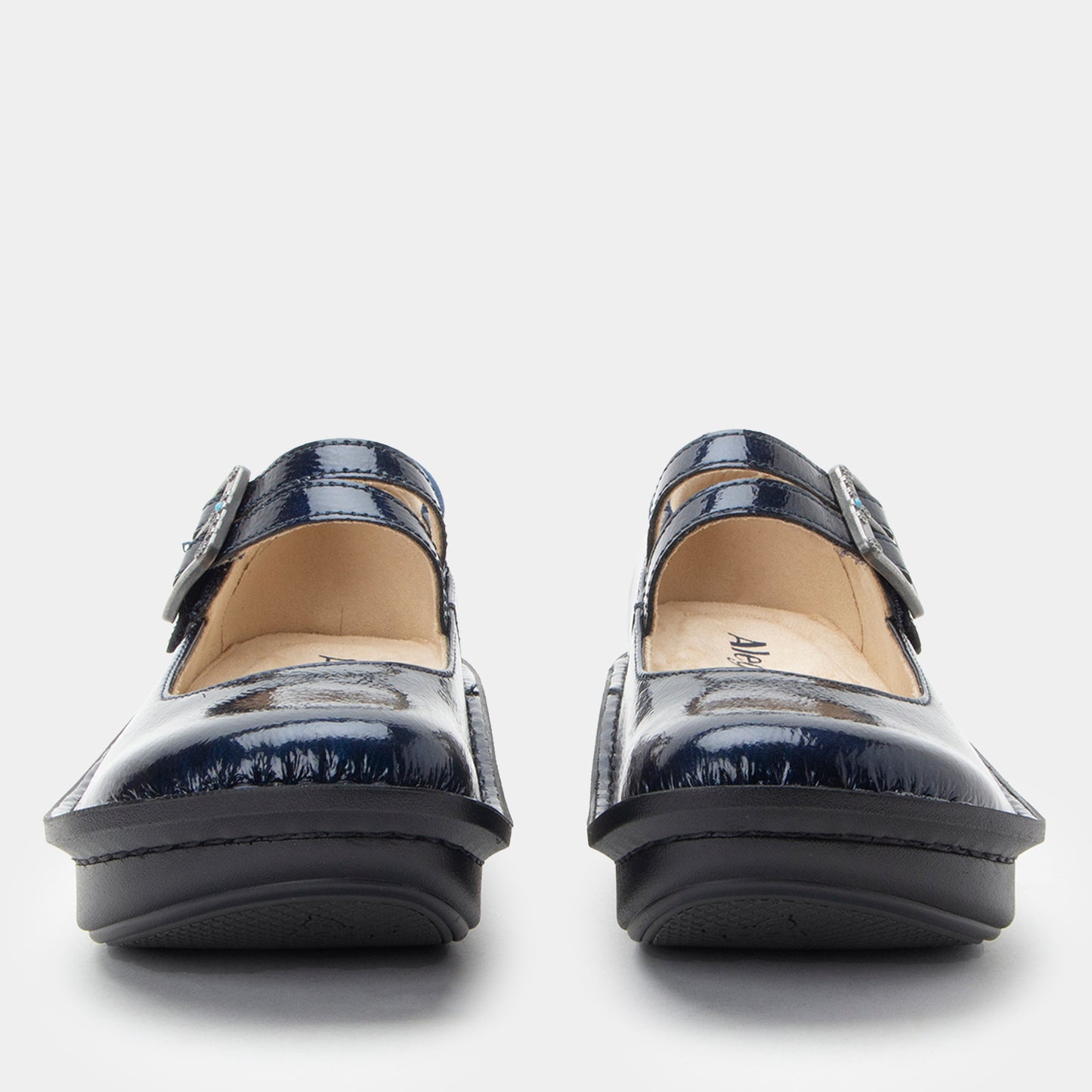 Pair of navy blue shoes with buckles on a white background