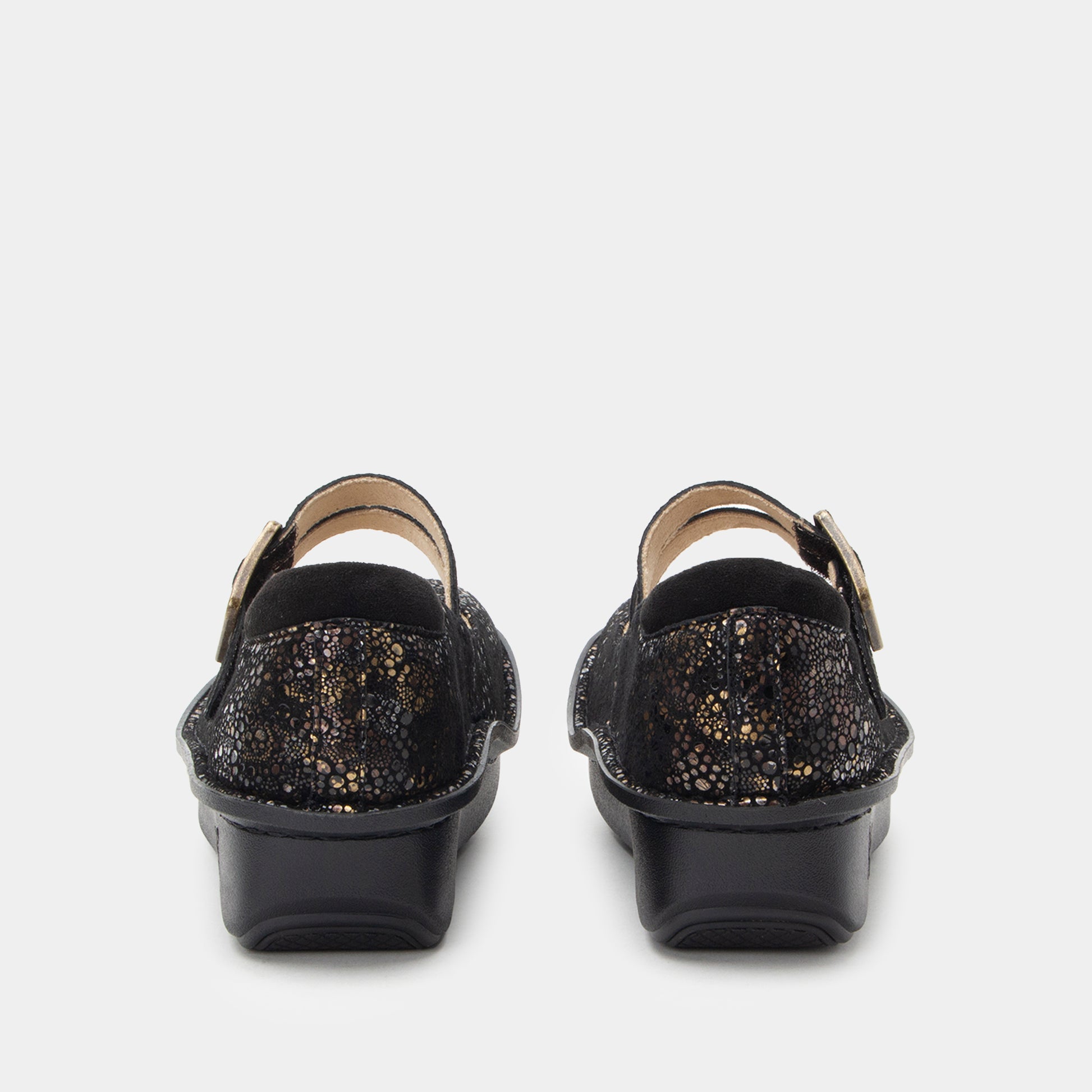 Black glittery shoes with gold buckles on a white background