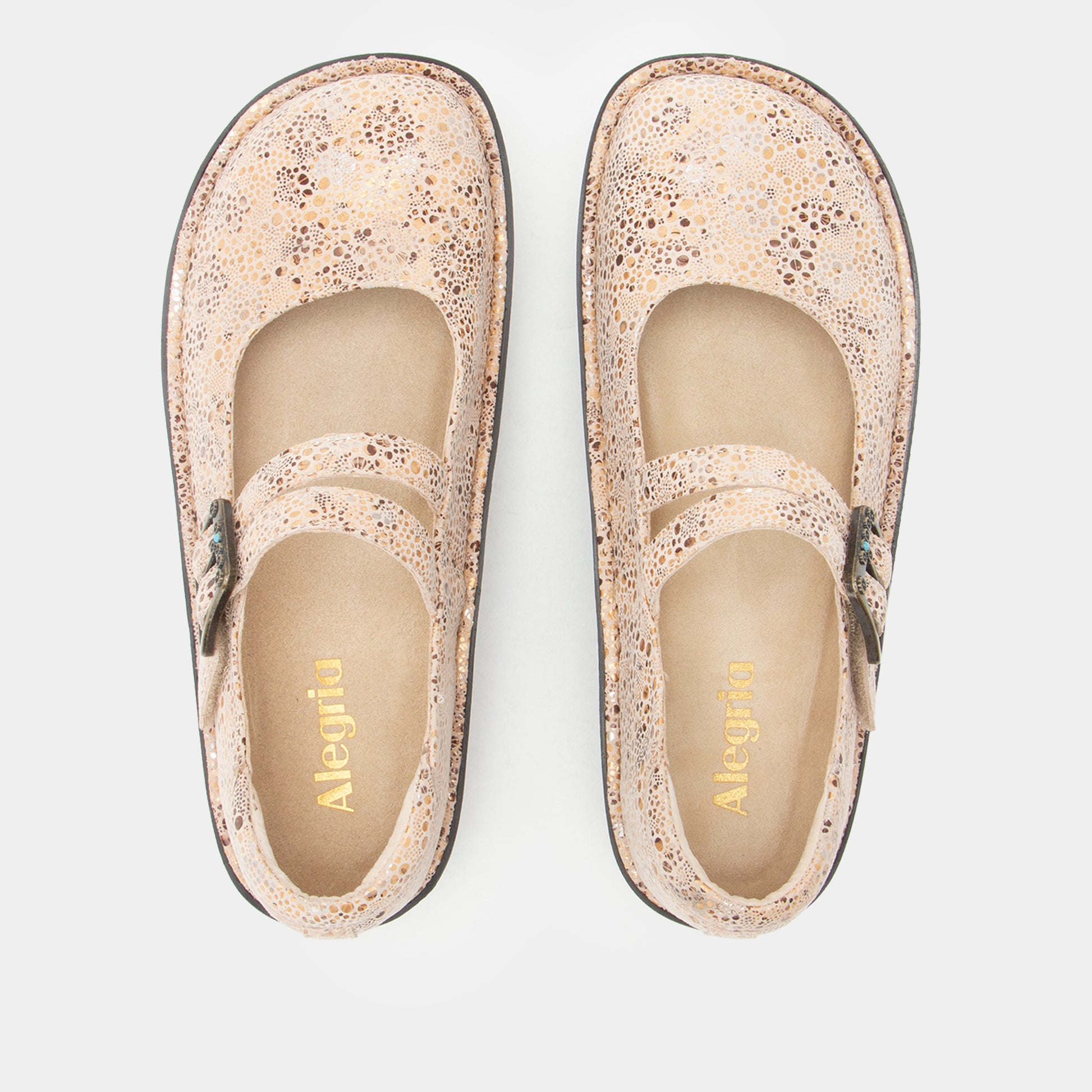 A pair of Alegria Mary Jane style shoes in a textured beige and brown speckled pattern, shown from a top-down view on a light gray background.