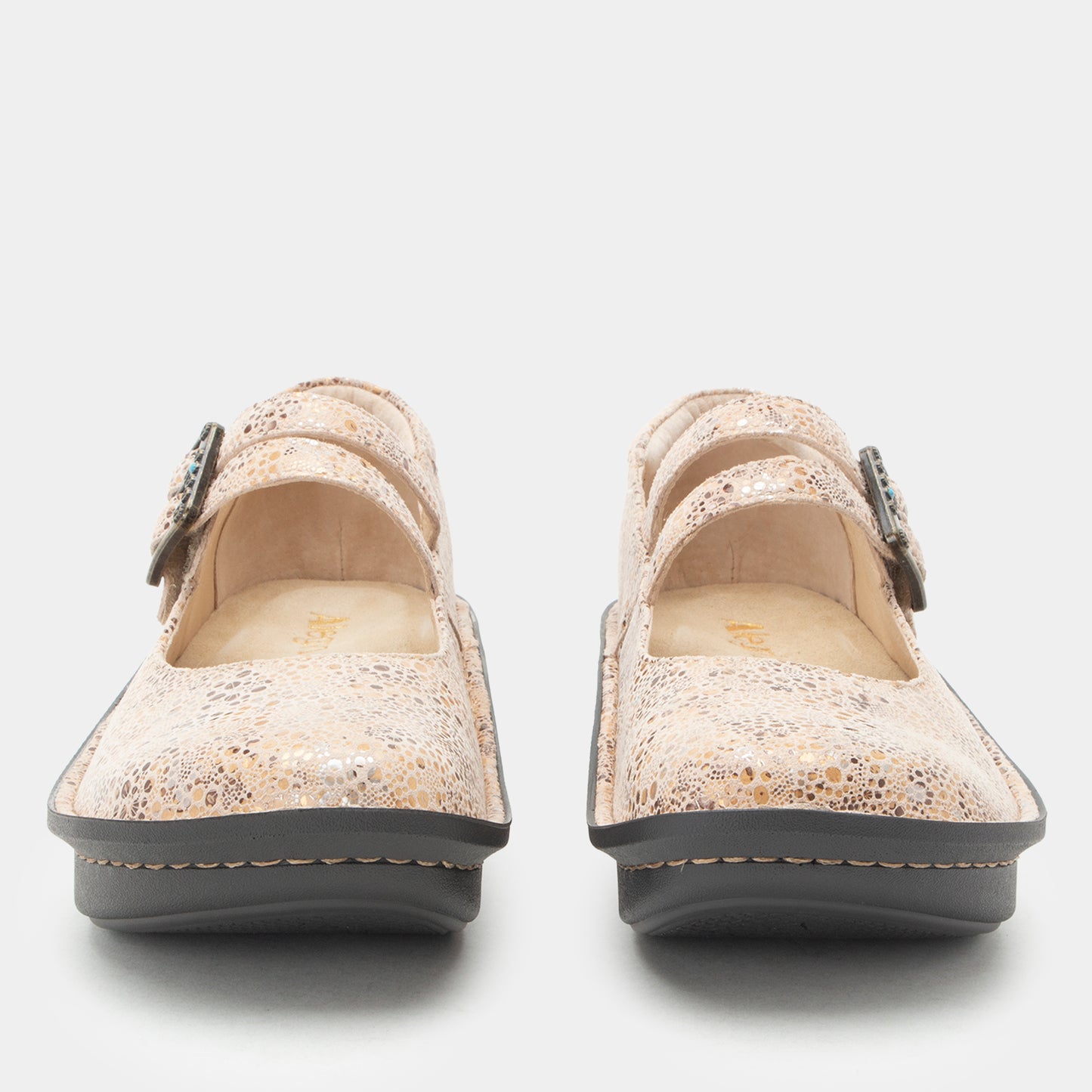 A pair of women's Mary Jane style shoes in a textured beige and gold speckled material, featuring double straps with silver-tone buckles and dark gray soles, shown from a front-facing perspective on a light gray background.