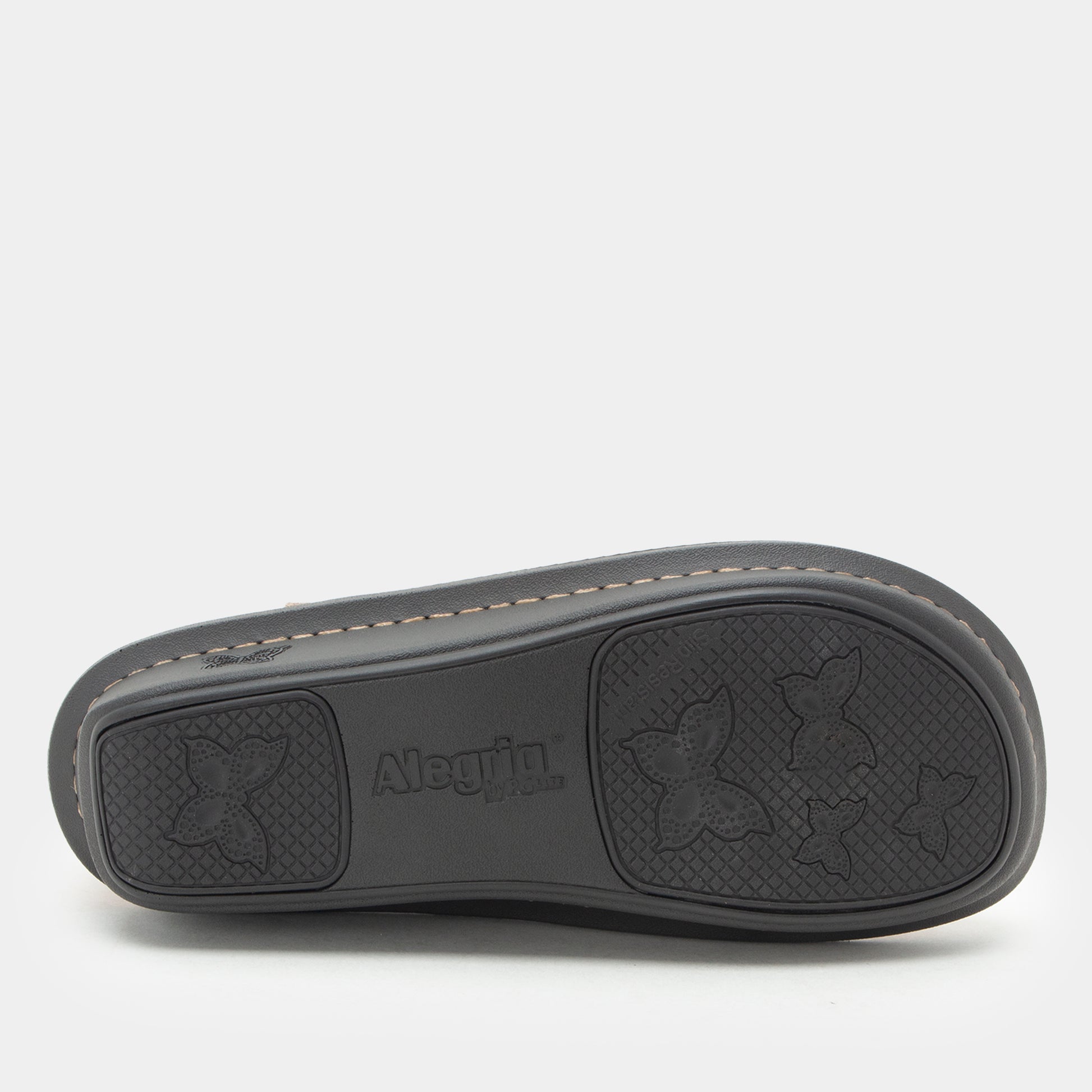 The black rubber outsole of a shoe, featuring embossed floral motifs and the brand name 'Albuilla' in the center, photographed against a light gray background.