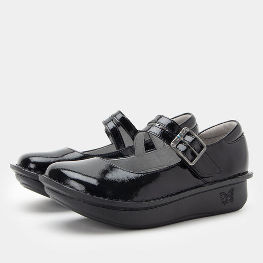 Black patent leather shoes with buckles on a white background