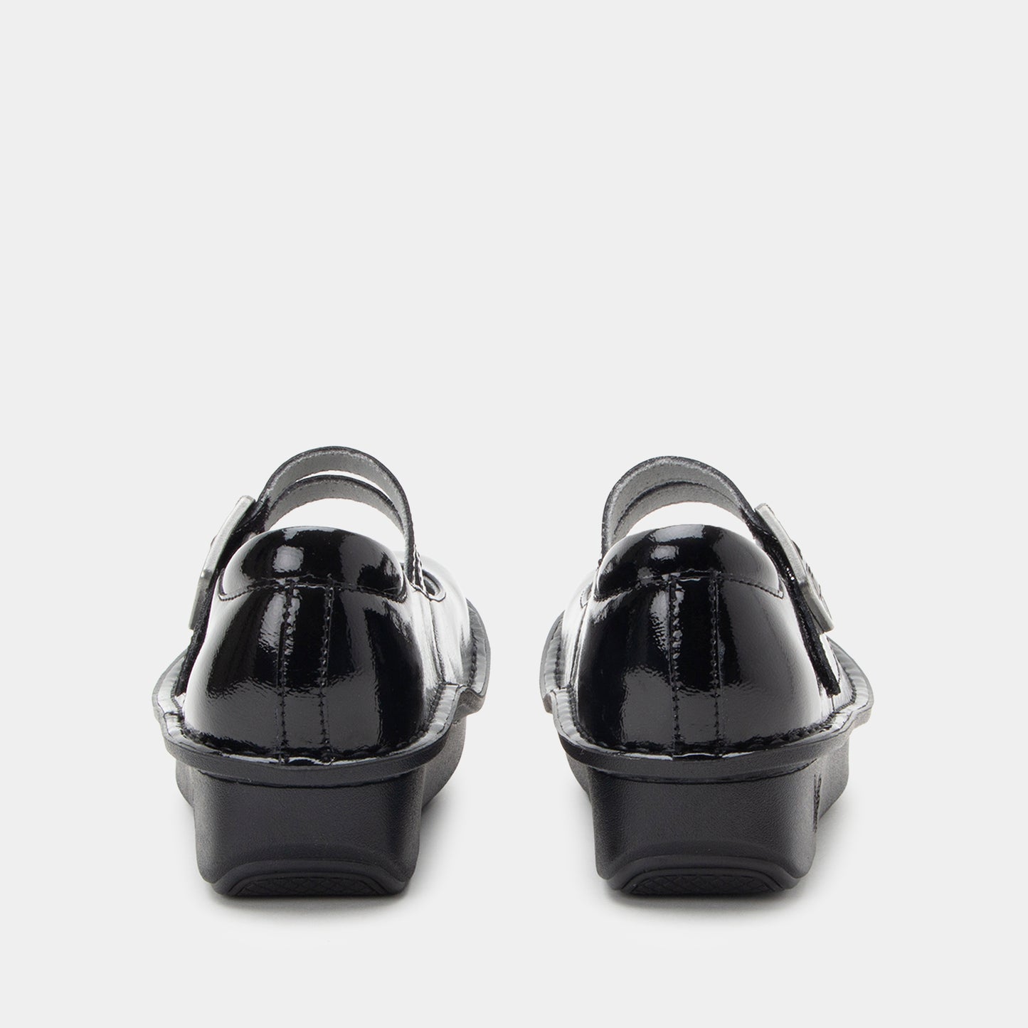 Black patent leather shoes on a white background