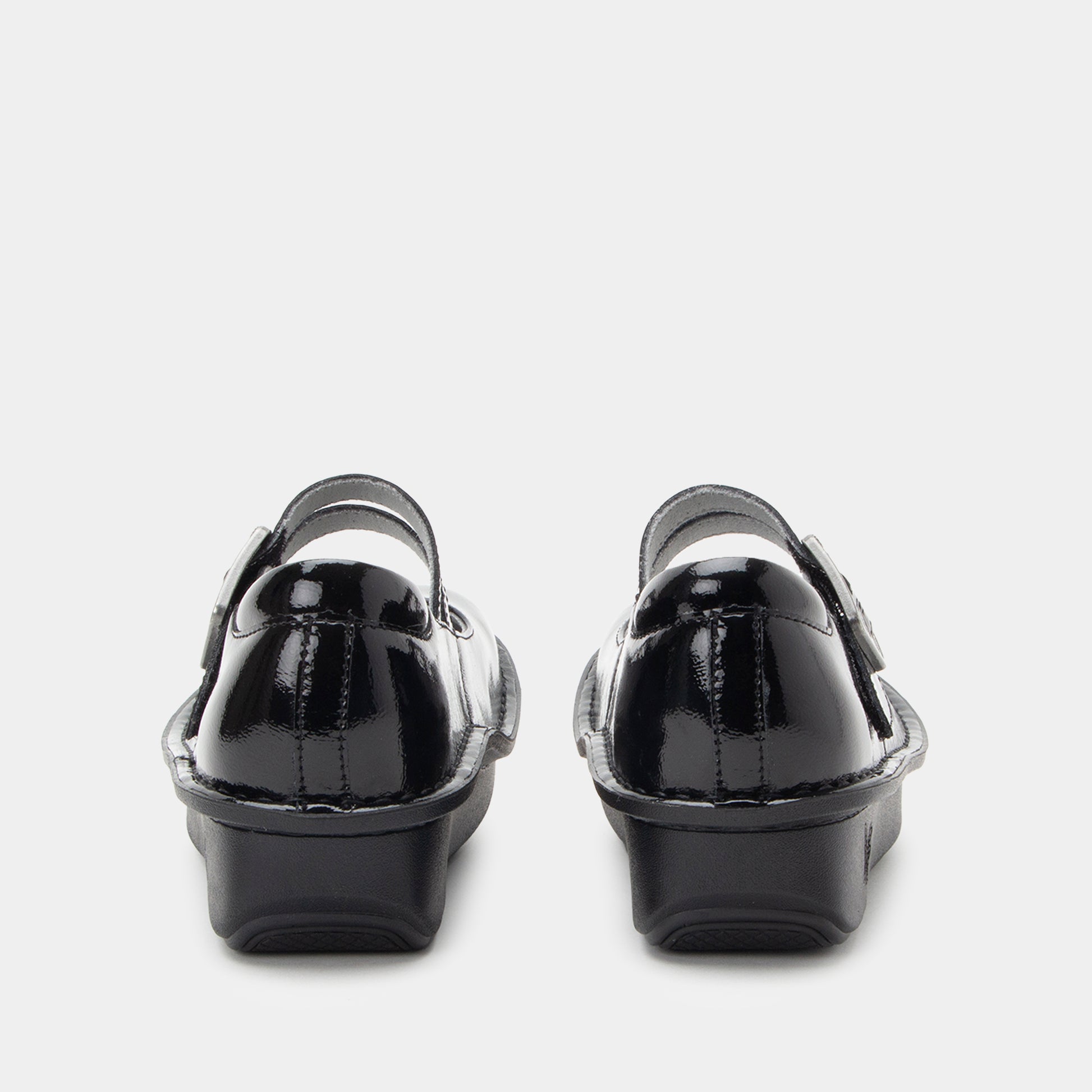 Black patent leather shoes on a white background