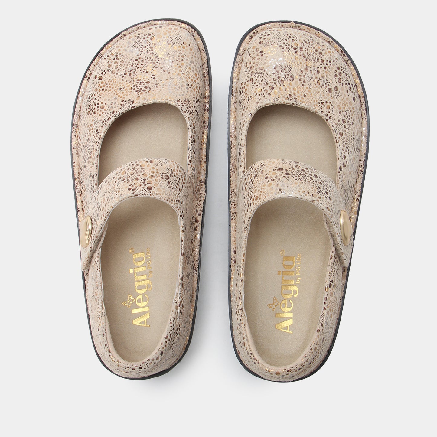 Pair of beige shoes with speckled pattern on a light gray background