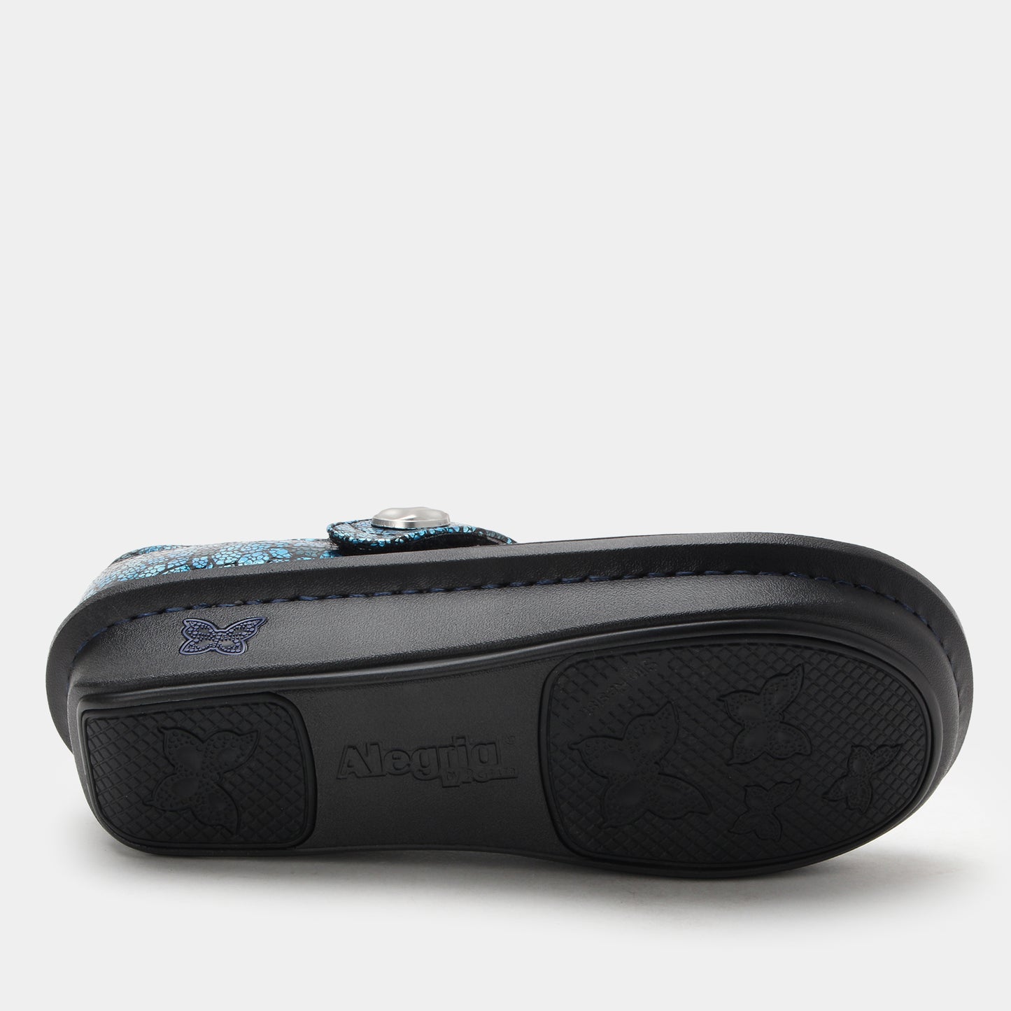 Black sandal with floral design on a white background