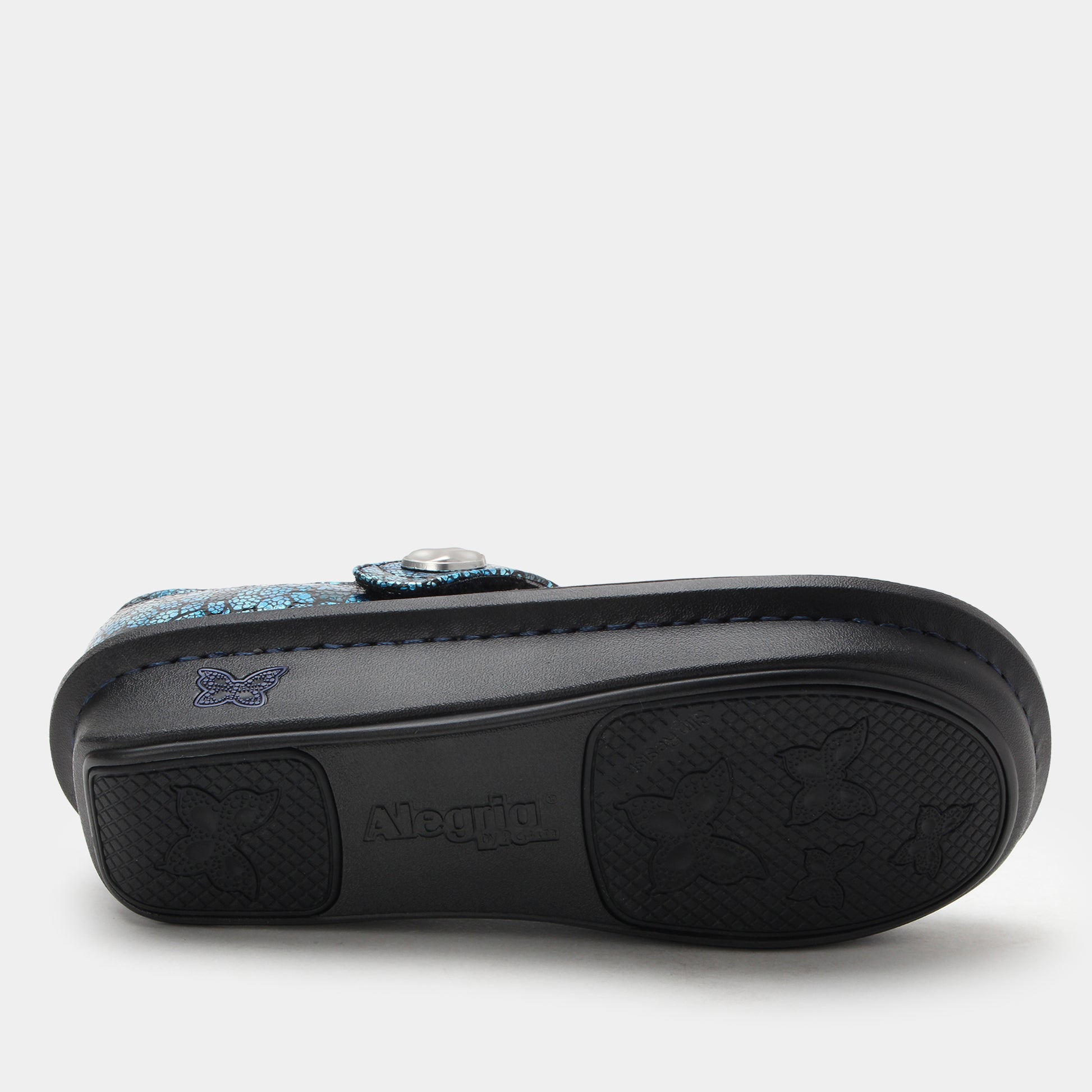 Black sandal with floral design on a white background