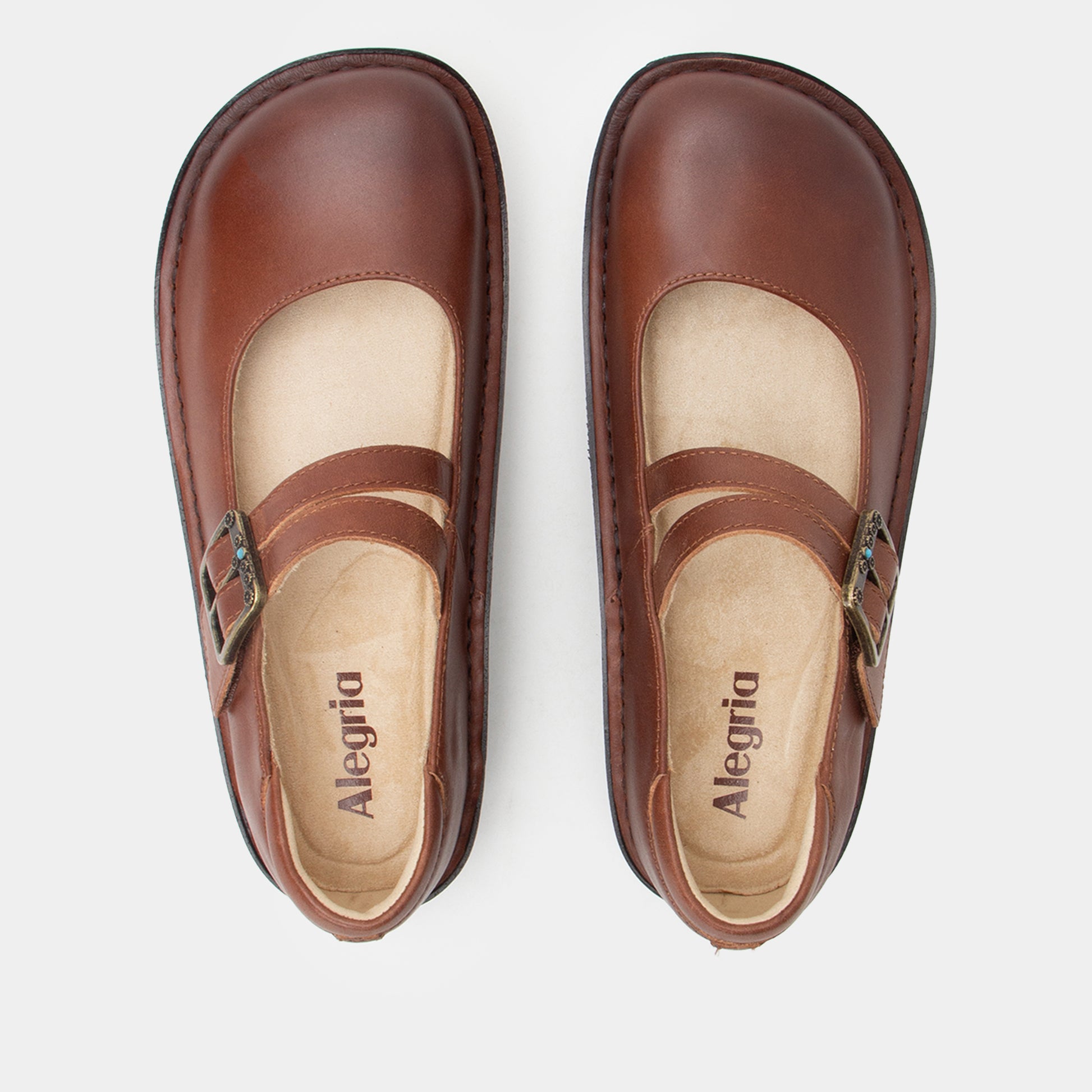Pair of brown Alegria shoes on a white background