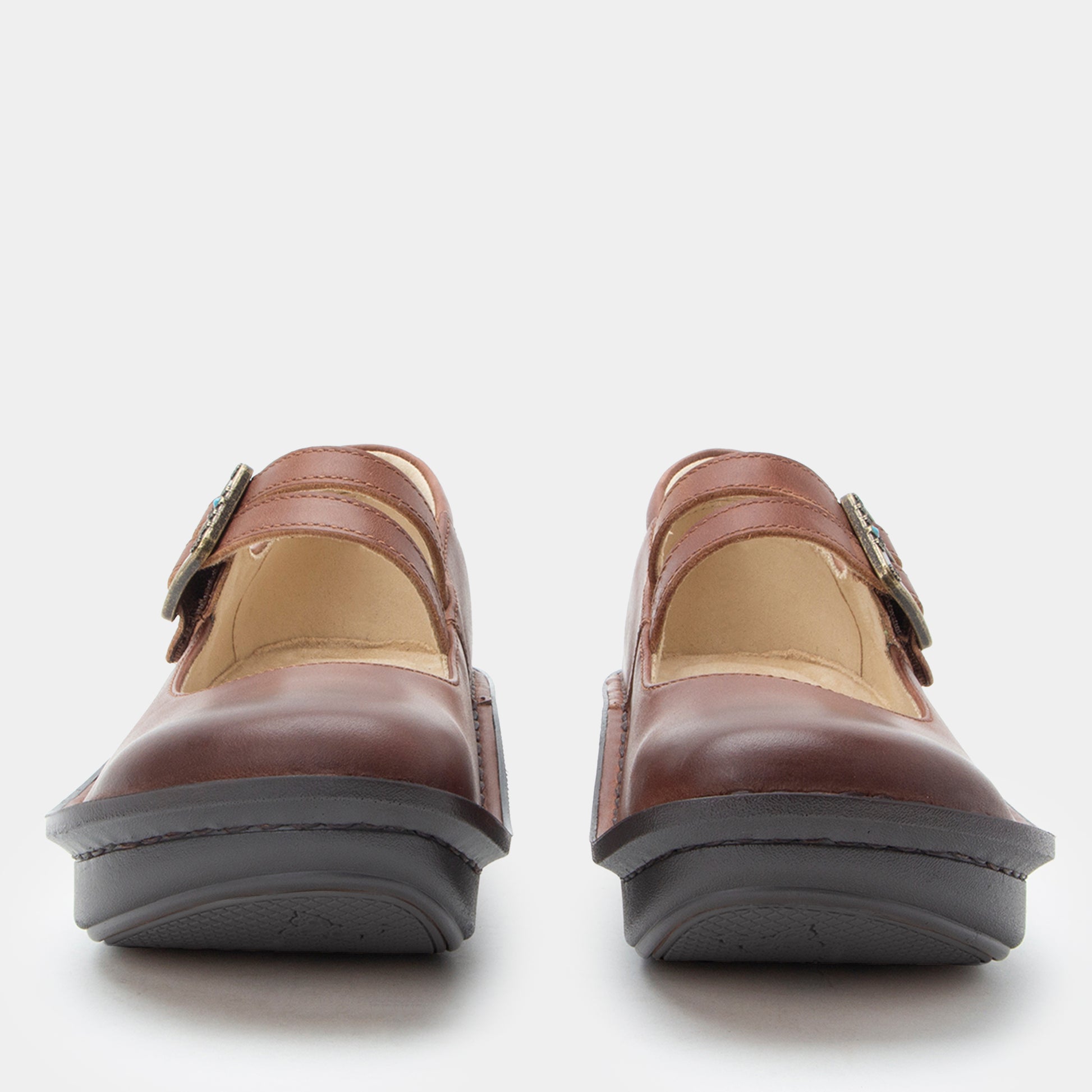 Pair of brown shoes with buckles on a white background