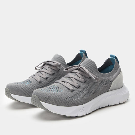 Gray athletic shoes with white soles on a light gray background