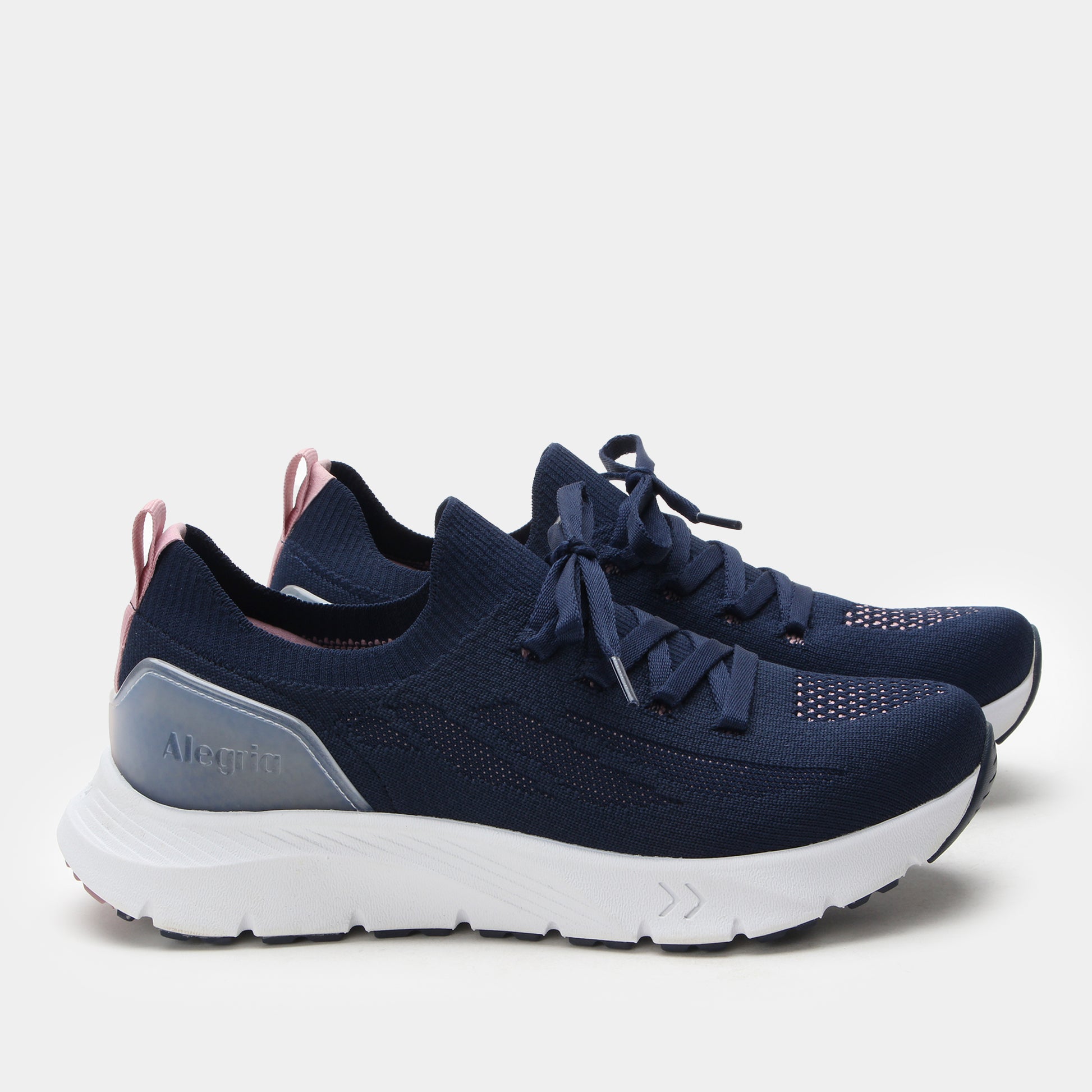 Navy running shoes with white soles on a light gray background