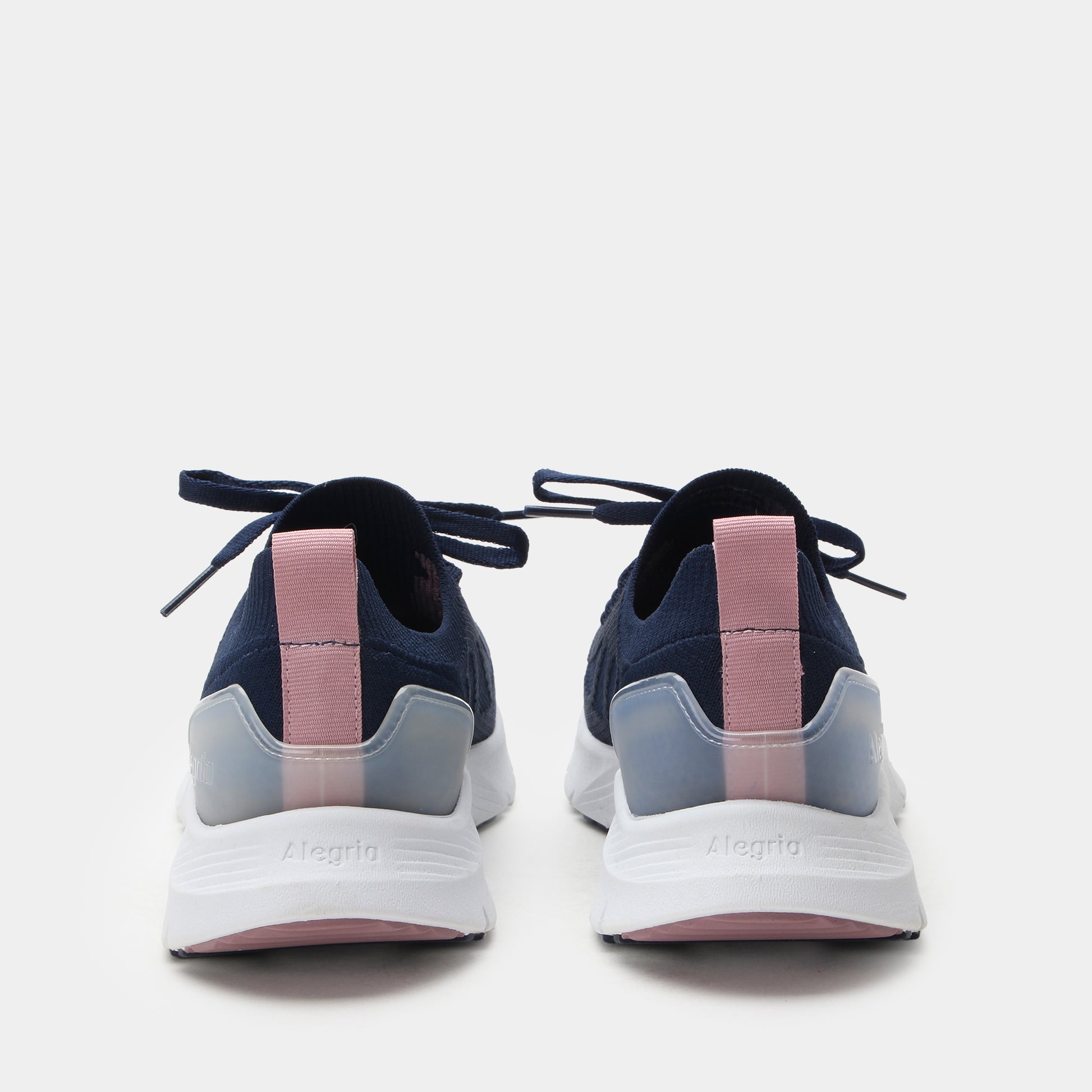 Navy and pink sneakers with white soles on a light gray background