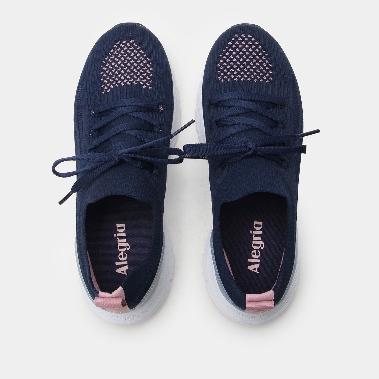 Navy blue sneakers with white soles on a light gray background