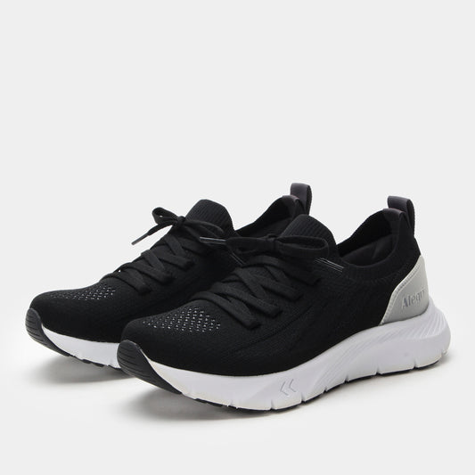 Black athletic shoes with white soles on a light gray background