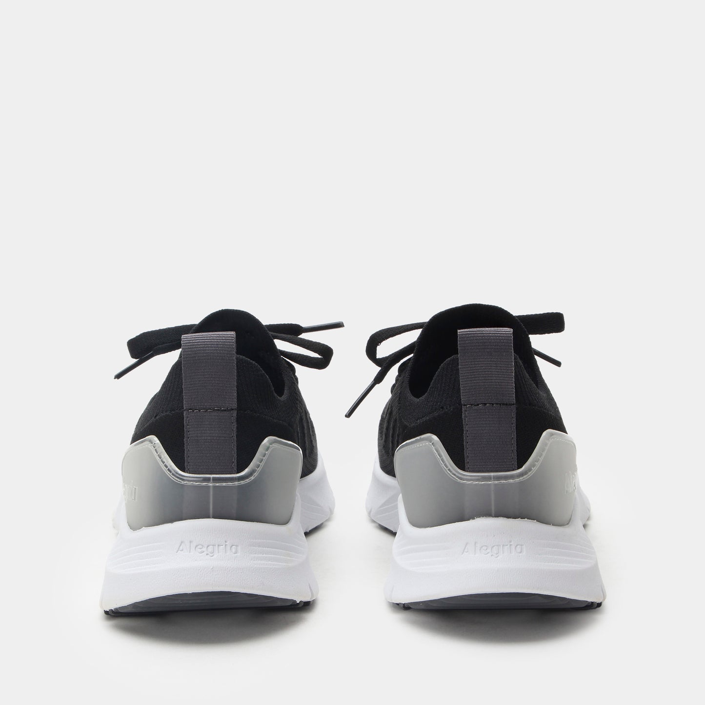 Black and gray sneakers with white soles on a light gray background