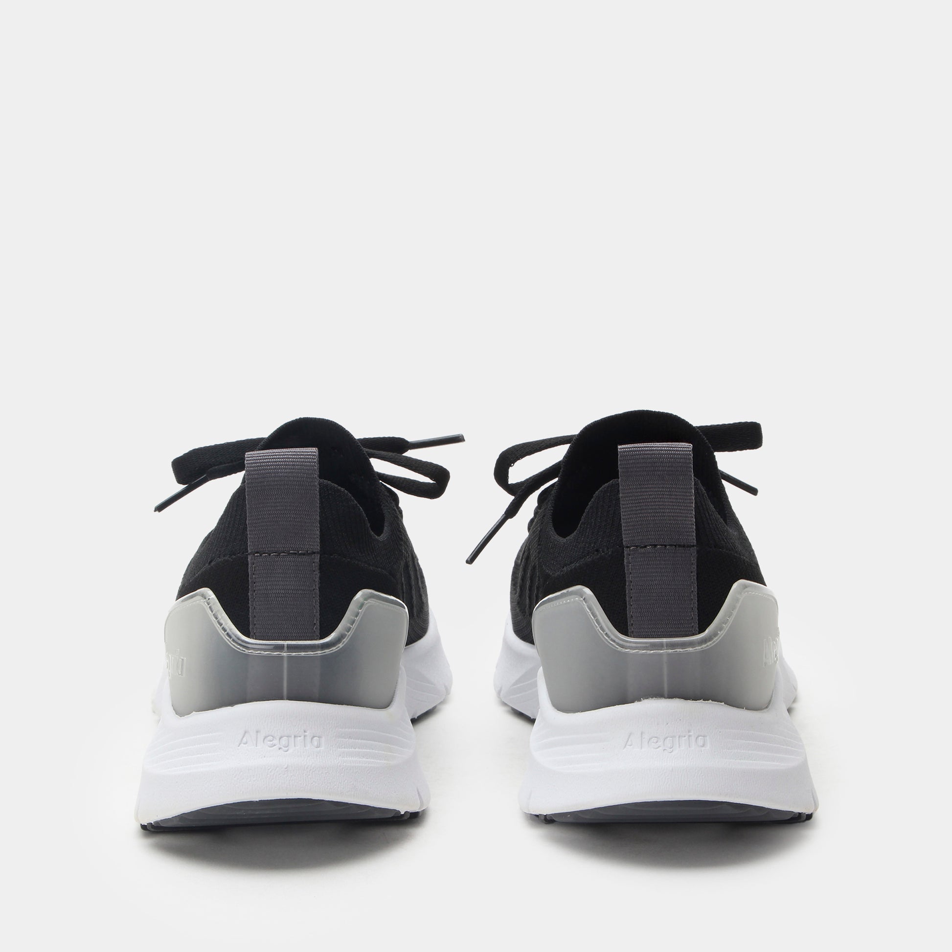 Black and gray sneakers with white soles on a light gray background