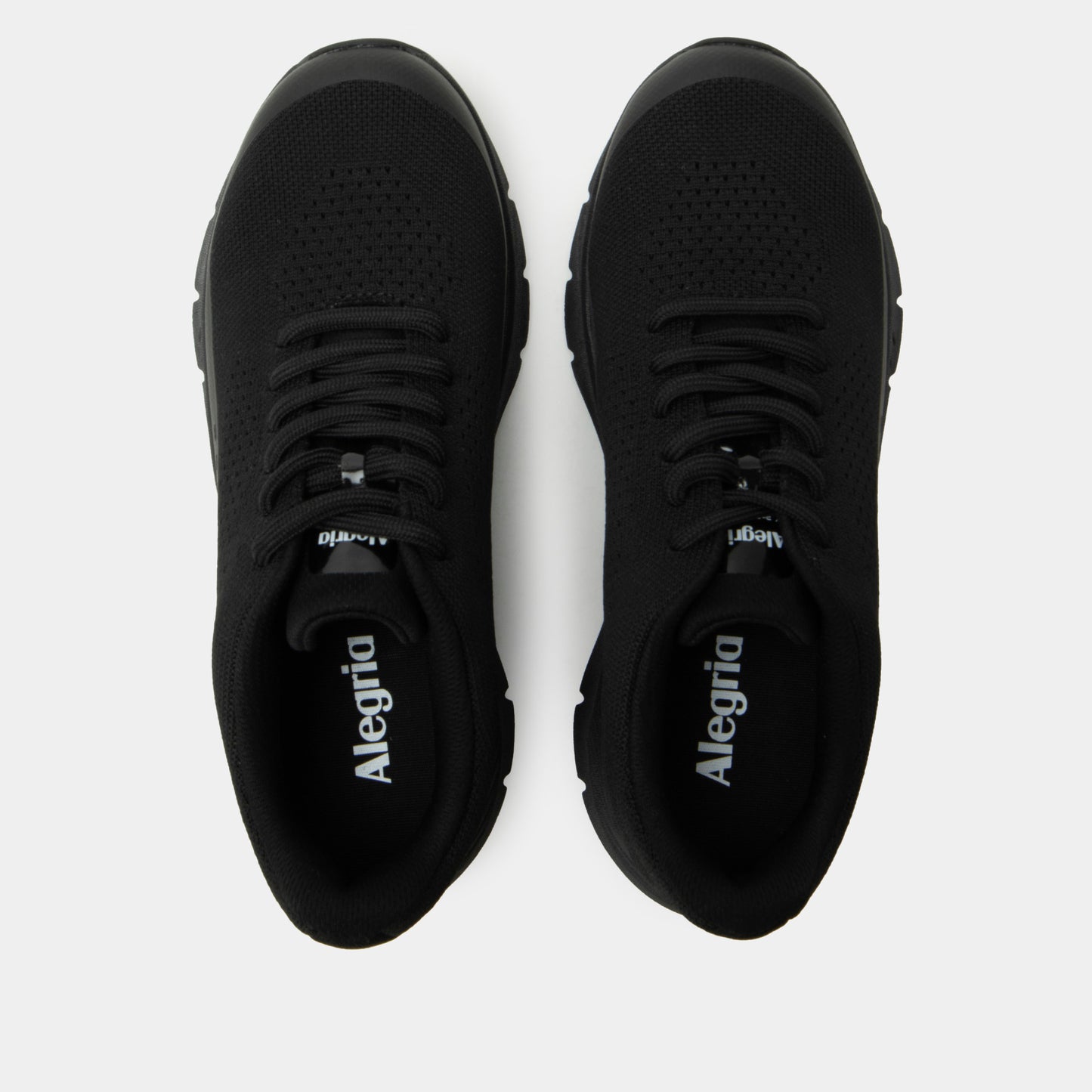 Pair of black Alegria shoes on a white background