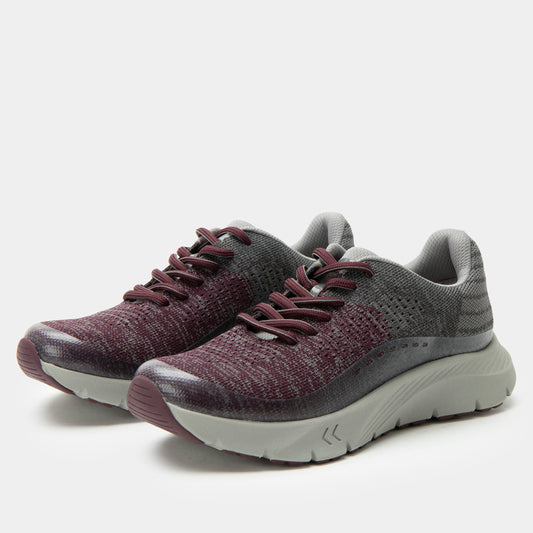 Pair of maroon and gray running shoes on a white background