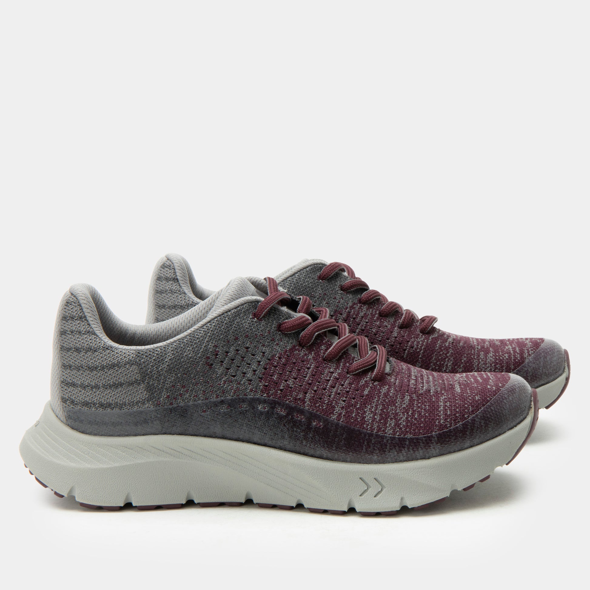 Pair of gray and purple running shoes on a white background