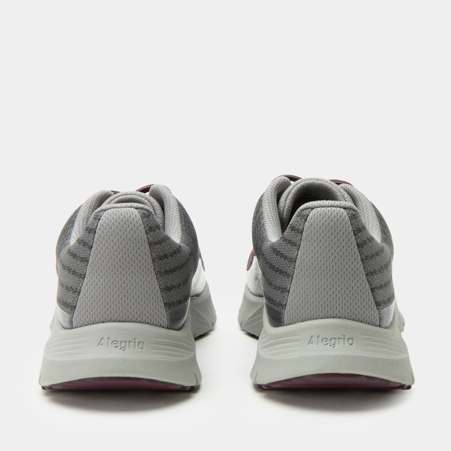Gray athletic shoes with 'Alegria' branding on a white background
