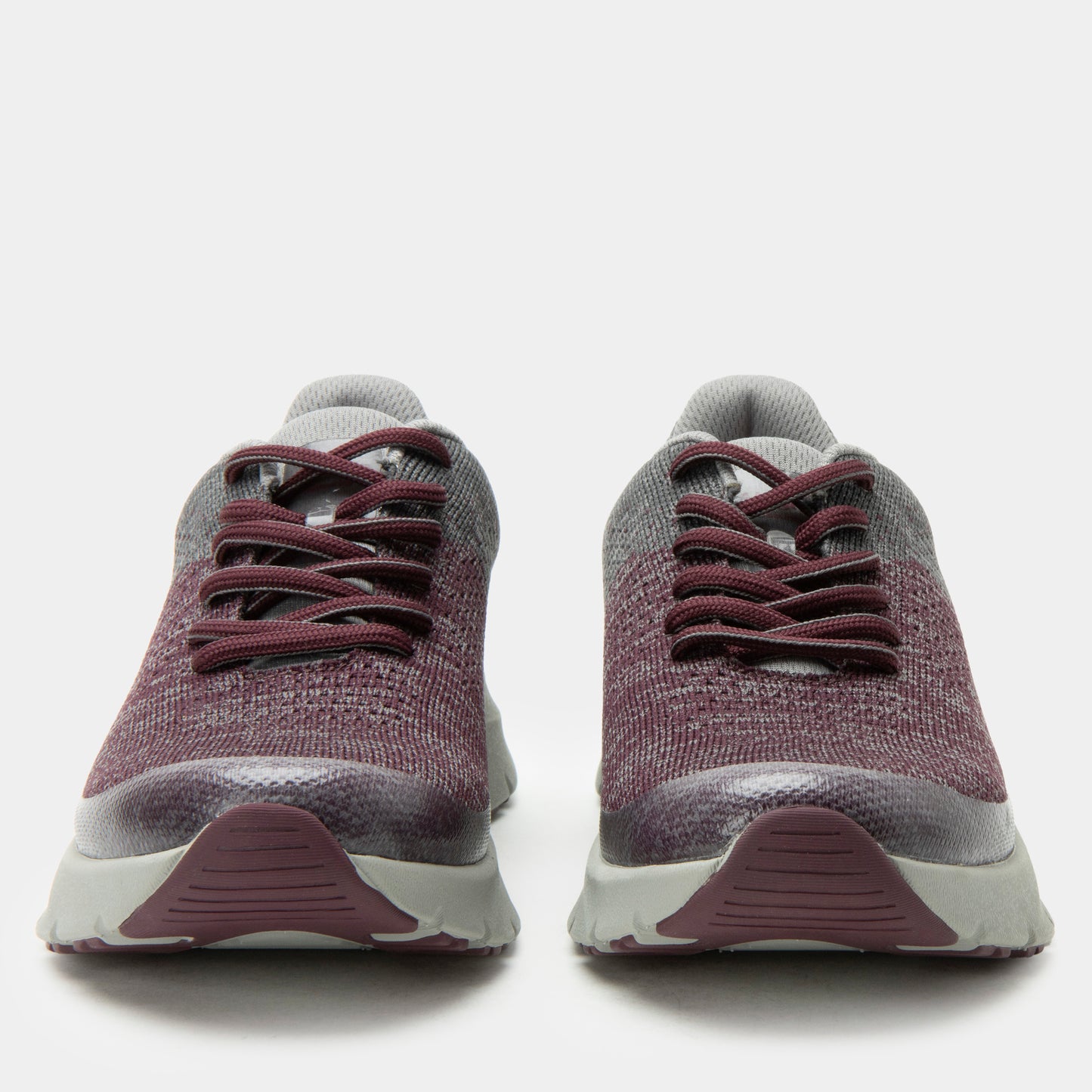 Pair of maroon and gray sneakers on a white background