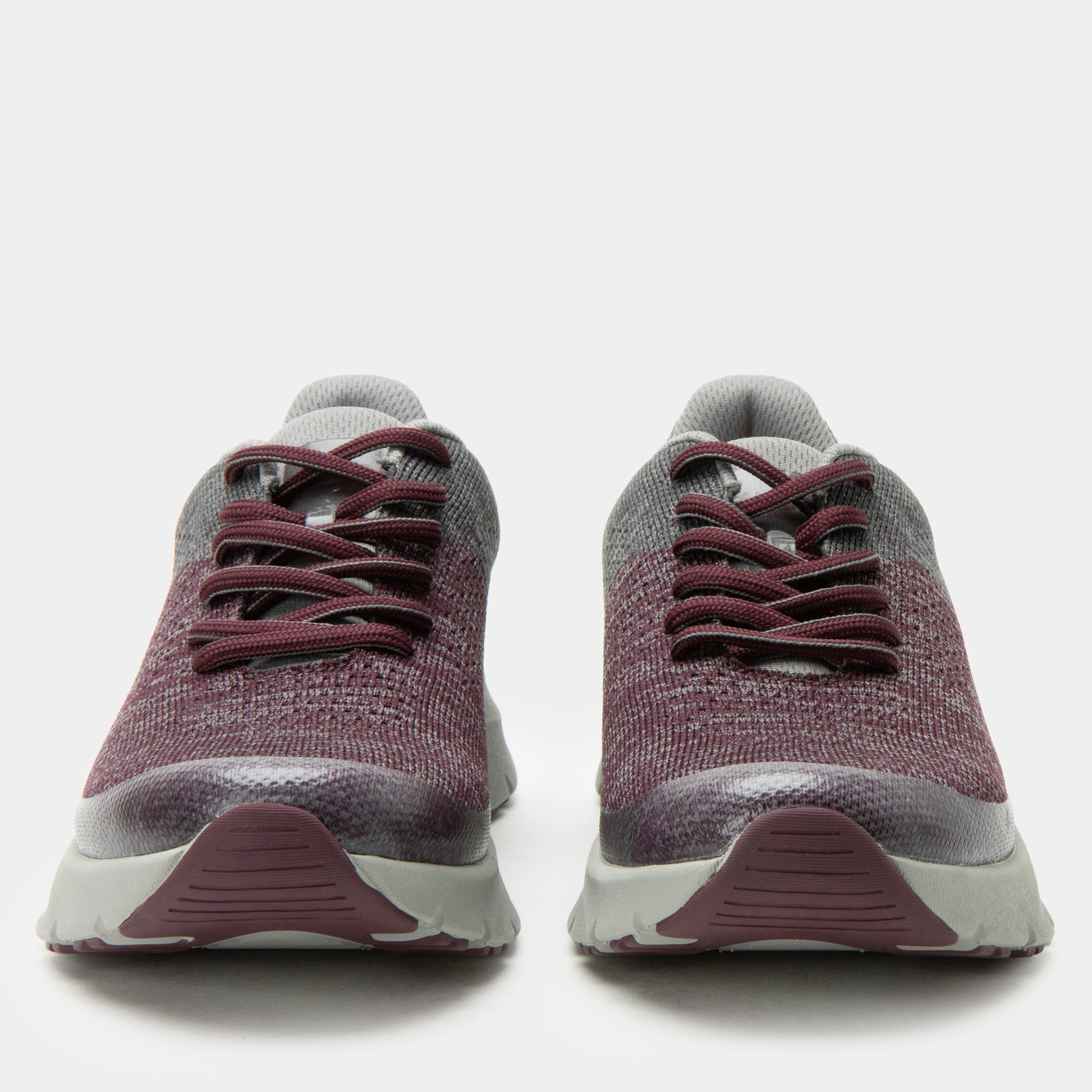 Pair of maroon and gray sneakers on a white background