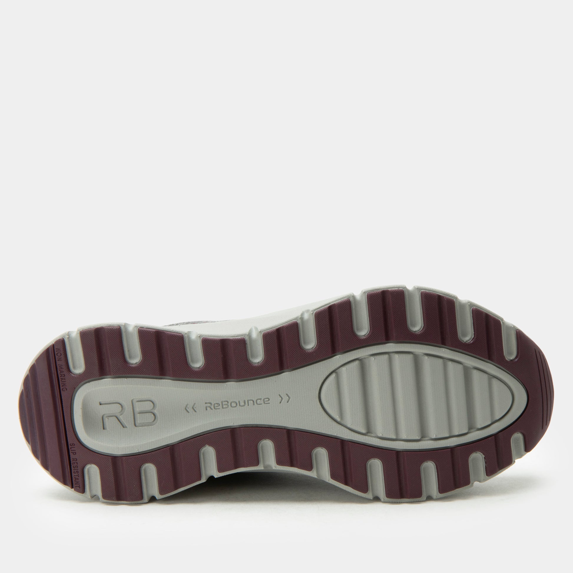 Close-up of a shoe sole with 'RB' branding on a white background