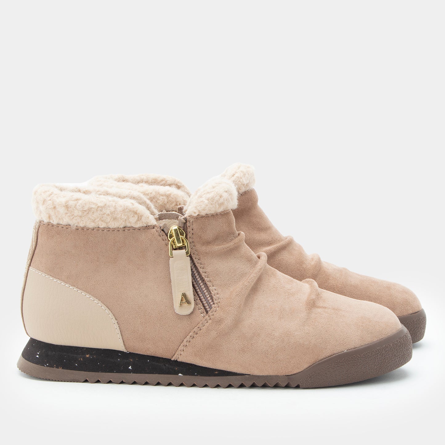 A pair of women's mid-calf boots in beige suede and faux-suede, featuring a cream sherpa lining, a side zipper with a gold-tone pull tab, and a black and brown sole, shown against a plain light gray background.