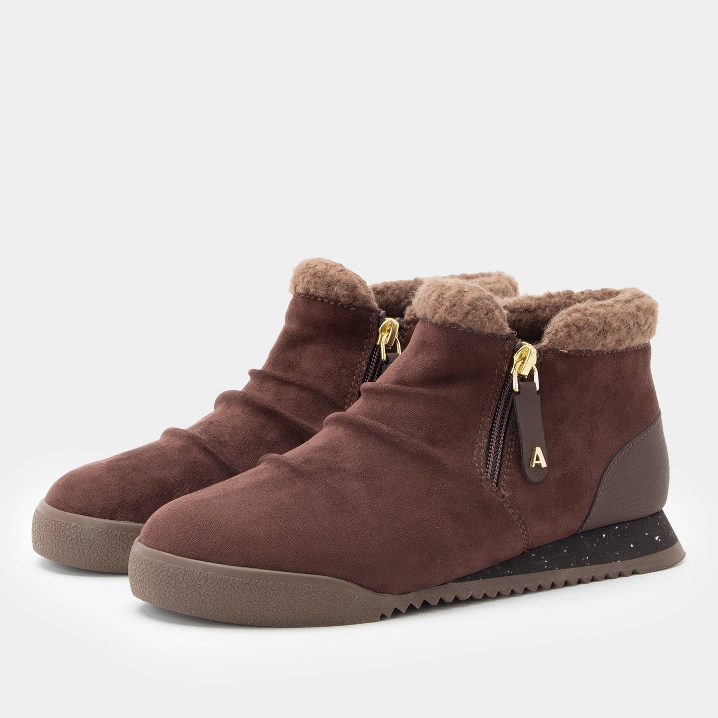 A pair of women's brown suede ankle boots with plush faux-fur trim, side zippers, and a chunky speckled sole, shown against a light gray background.