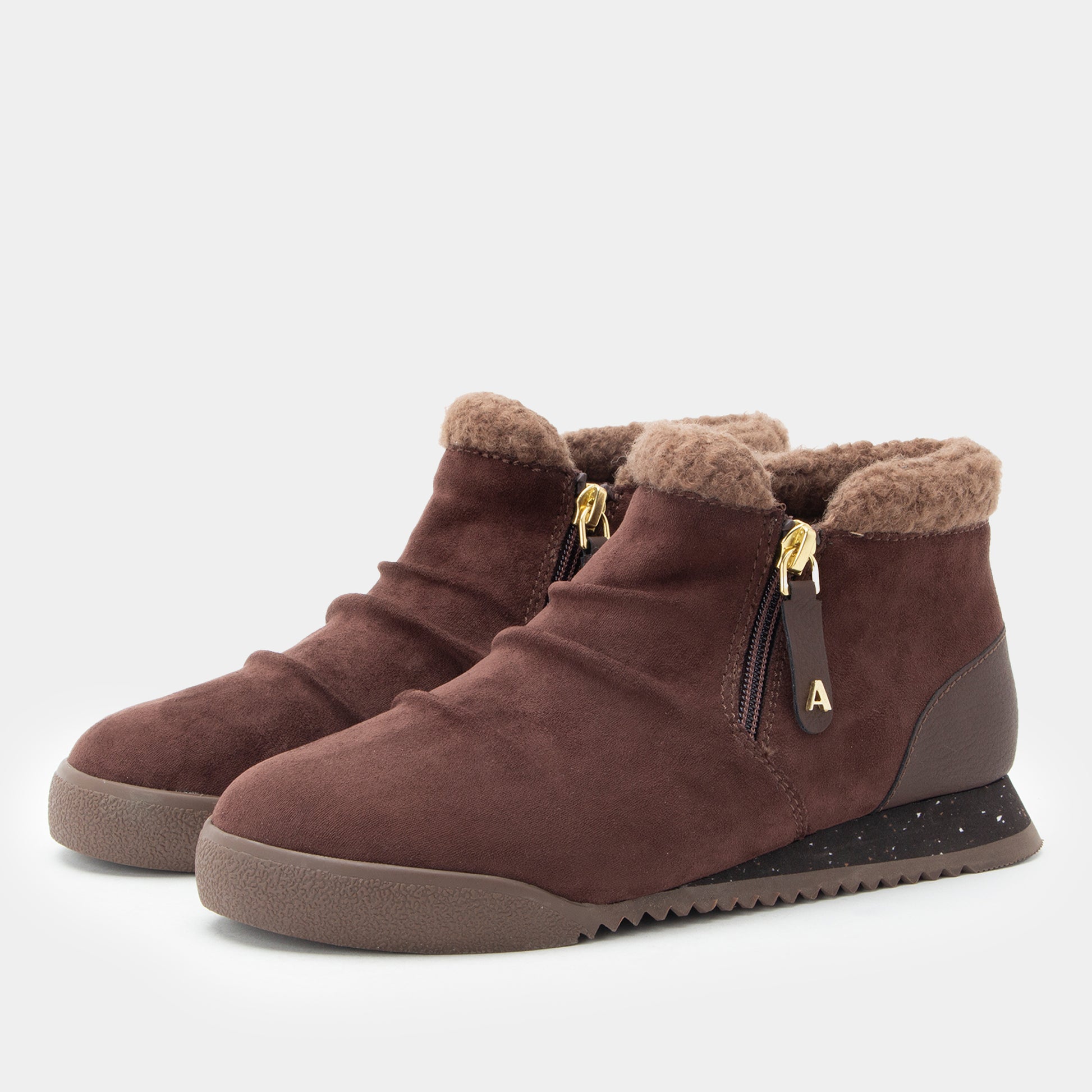 A pair of women's brown suede ankle boots with plush faux-fur trim, side zippers, and a chunky speckled sole, shown against a light gray background.
