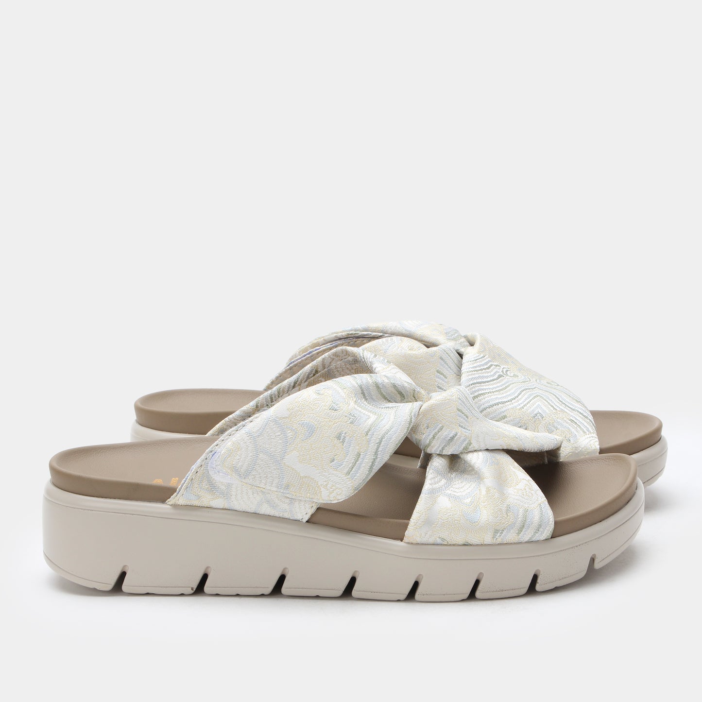 White sandal with a bow on a white background