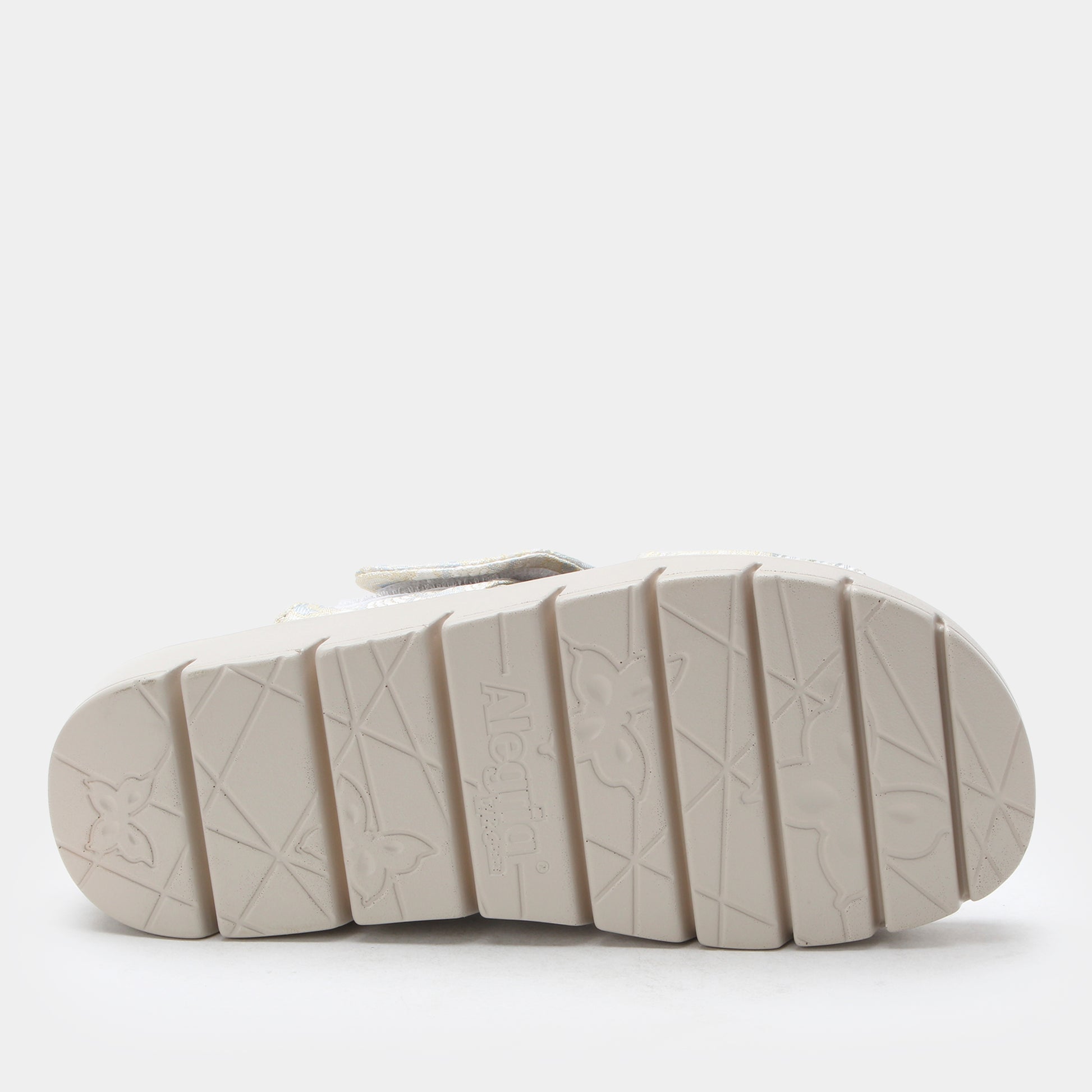 White sandal sole with embossed pattern on a white background