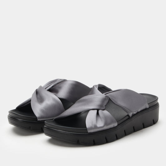 Black sandals with gray satin straps on a light gray background