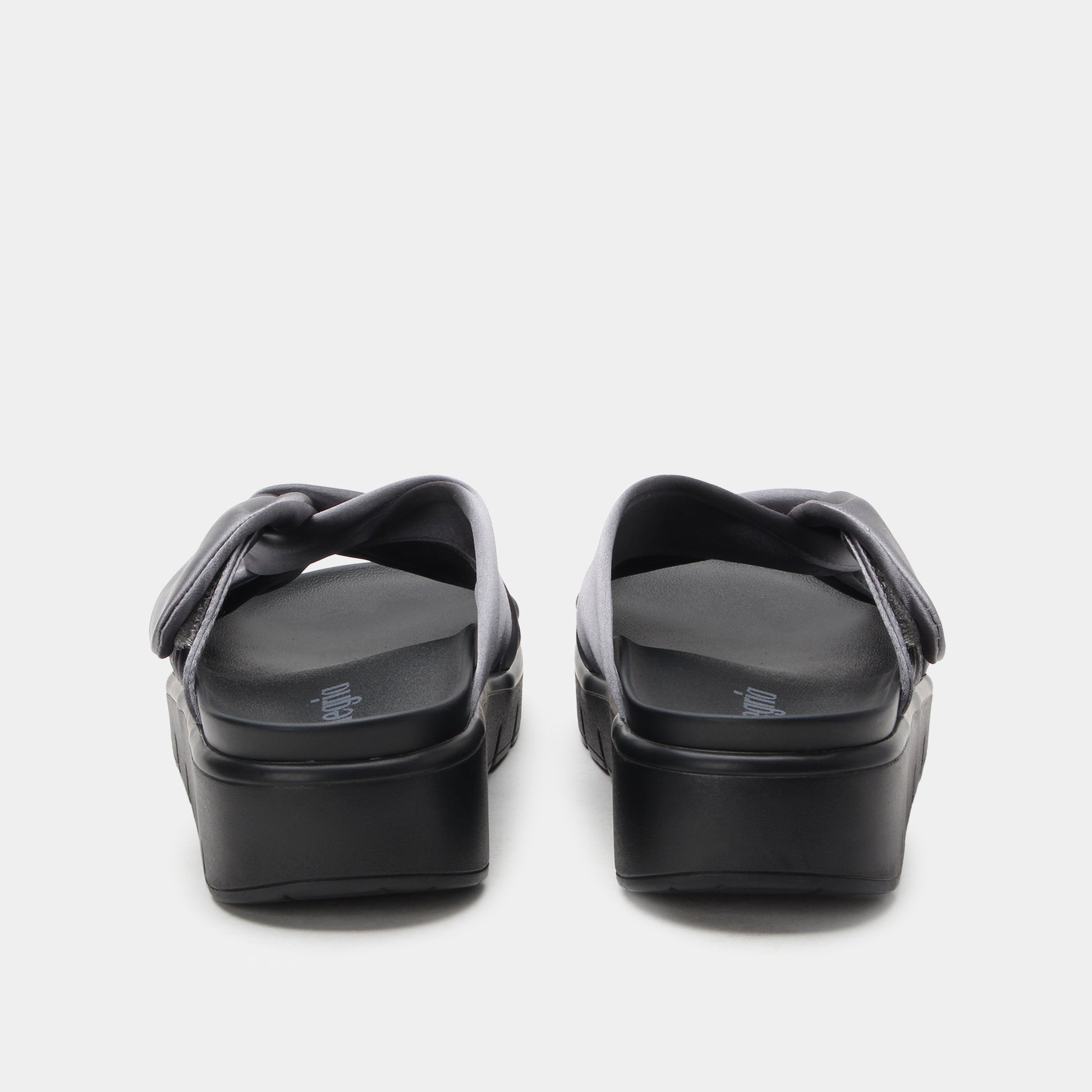 Black platform sandals on a white background
