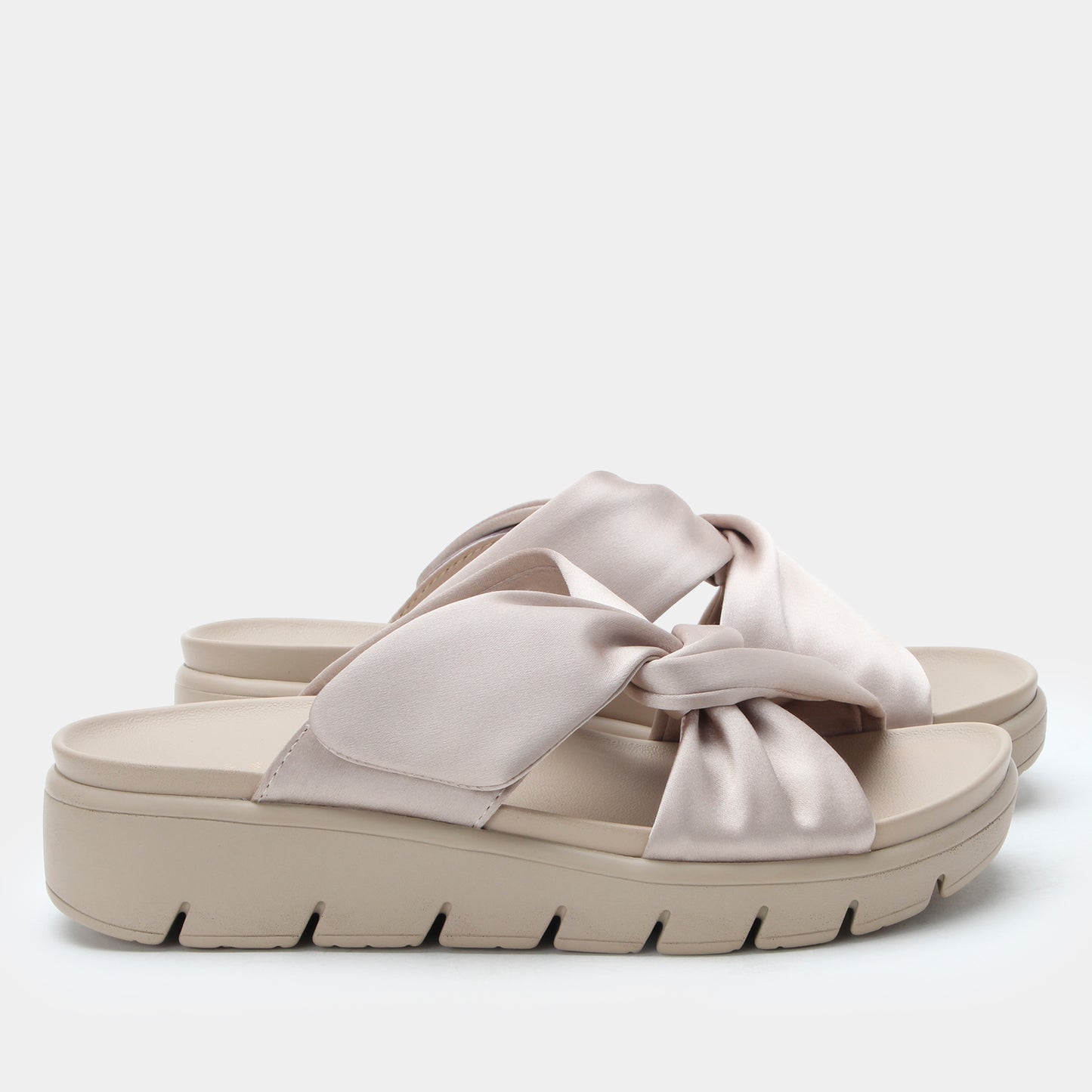 Beige sandal with a bow on a white background