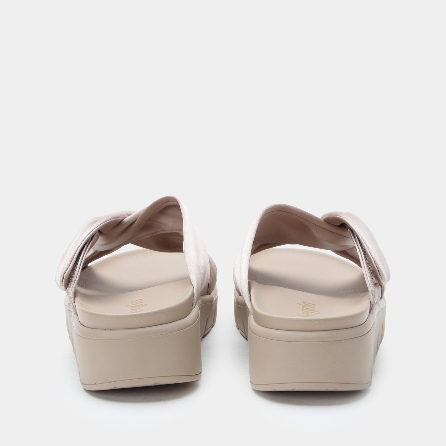 Pair of beige sandals on a white background