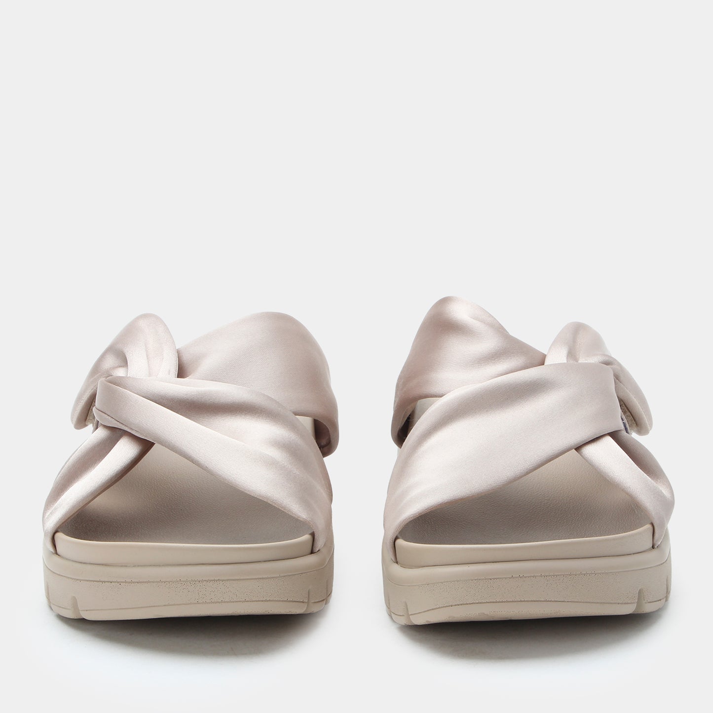 Pair of beige sandals on a white background