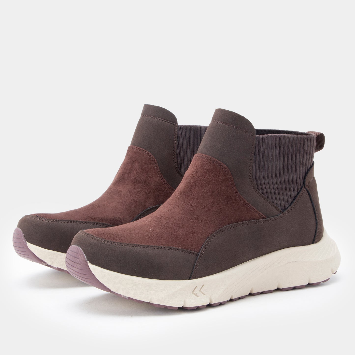 A pair of women's slip-on ankle boots in olive green and brown suede with gray elastic side panels and thick cream-colored soles, shown on a light gray background.