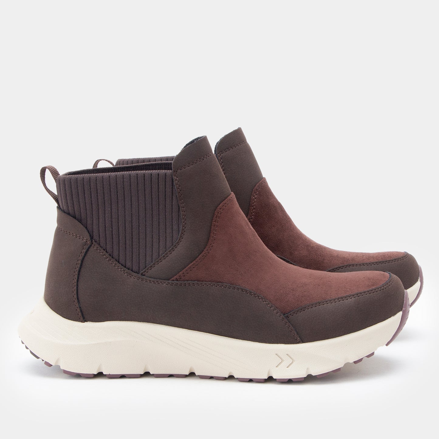 A pair of dark brown ankle boots with a ribbed dark gray elastic side panel and a chunky off-white sole, shown against a light gray background.