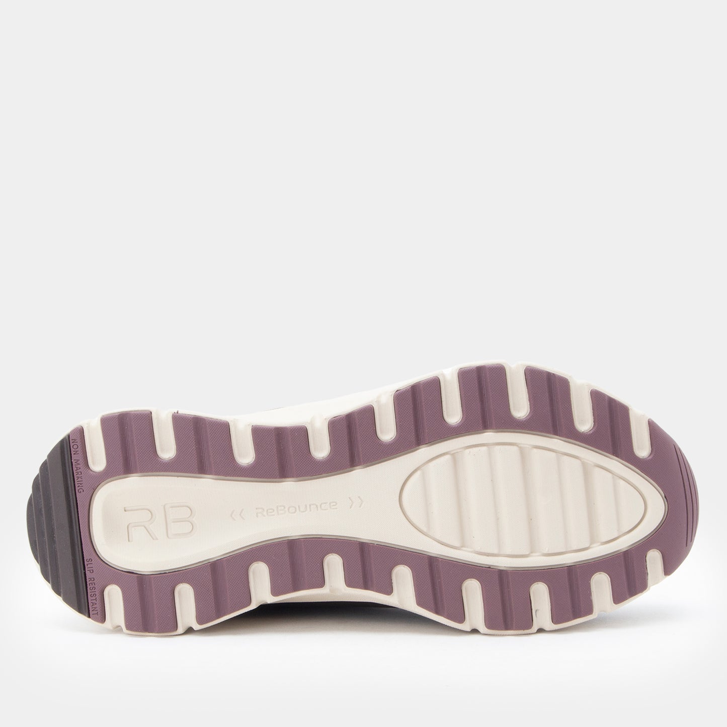 The outsole of a Rebound shoe in a dusty purple and off-white colorway, showing the tread pattern and the embossed 'RB' logo.