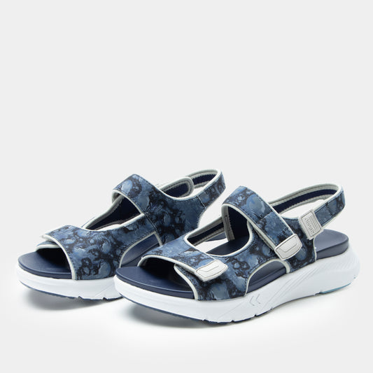 Pair of blue floral-patterned sandals on a white background