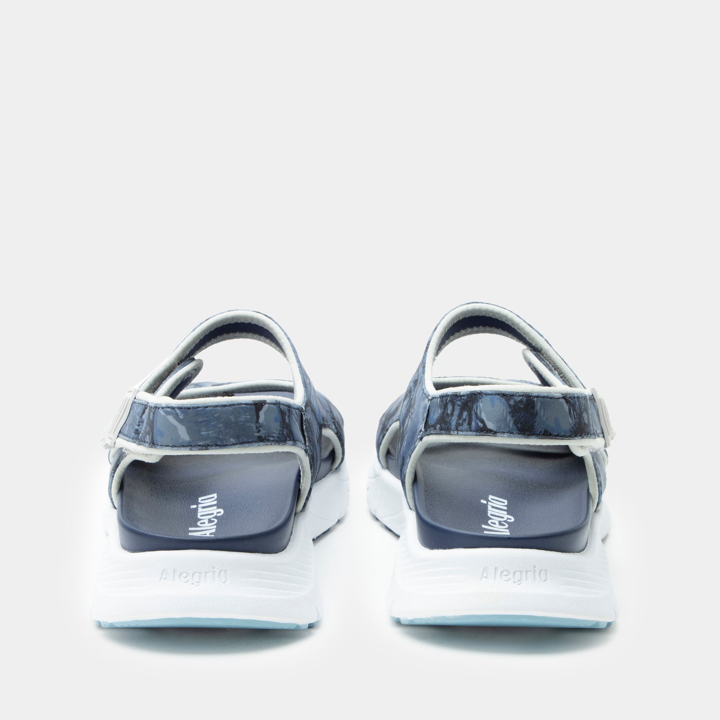 Pair of sandals with 'Mephisto' branding on a light gray background