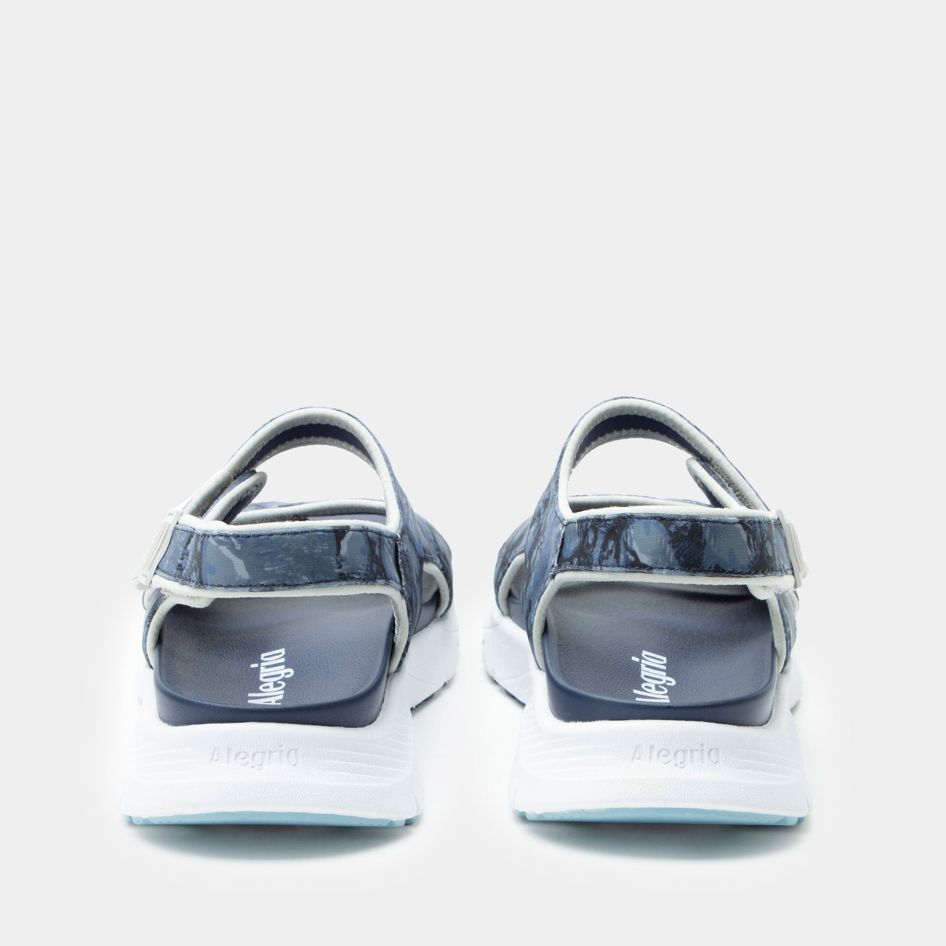 Pair of sandals with 'Mephisto' branding on a light gray background