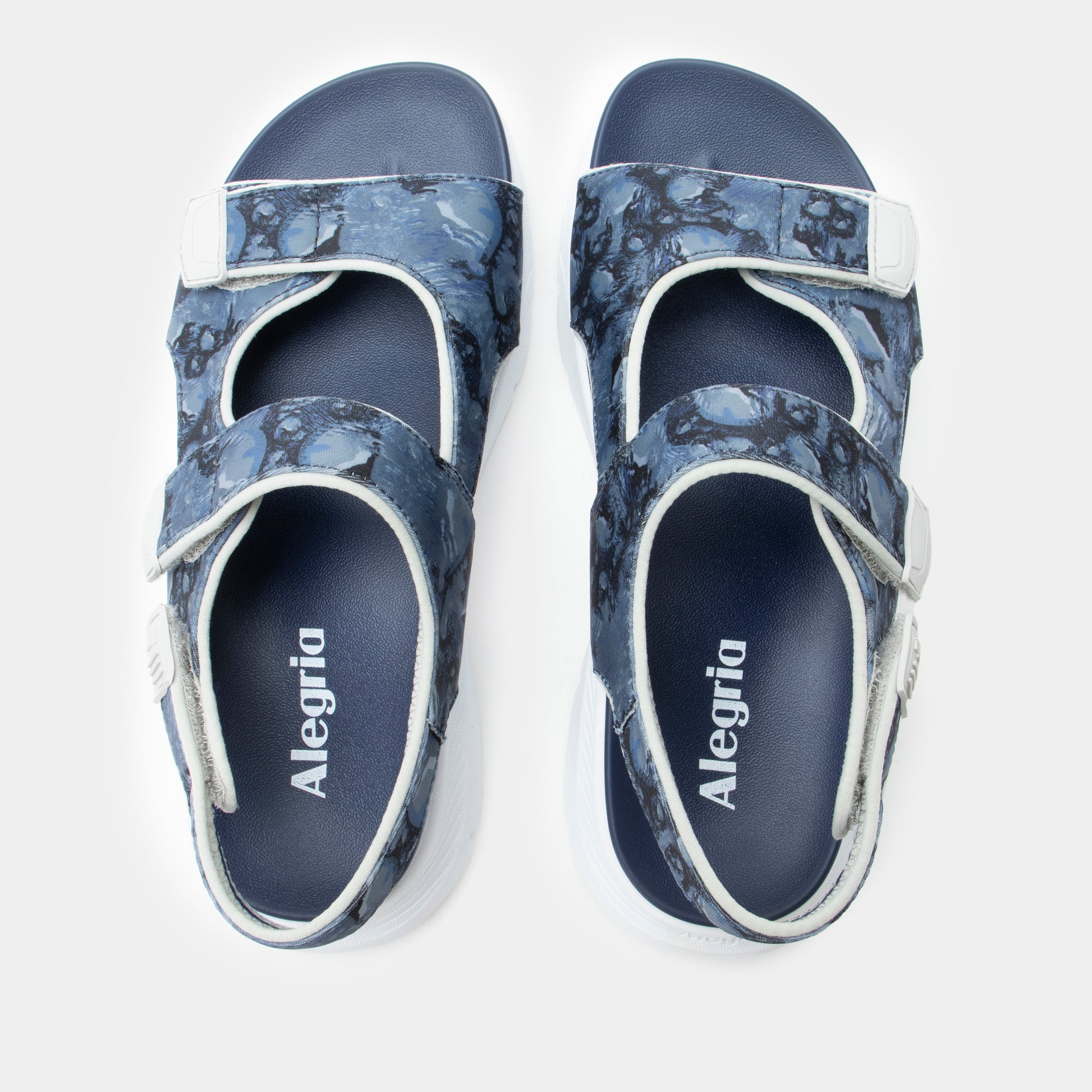Pair of blue sandals with floral pattern on a white background
