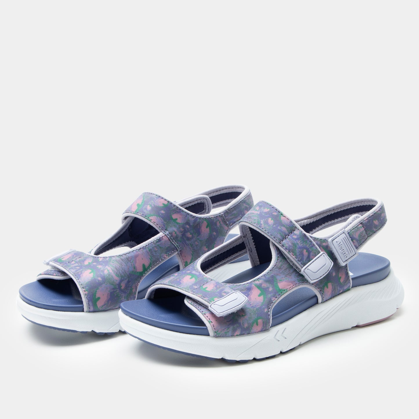 Pair of floral-patterned sandals on a white background