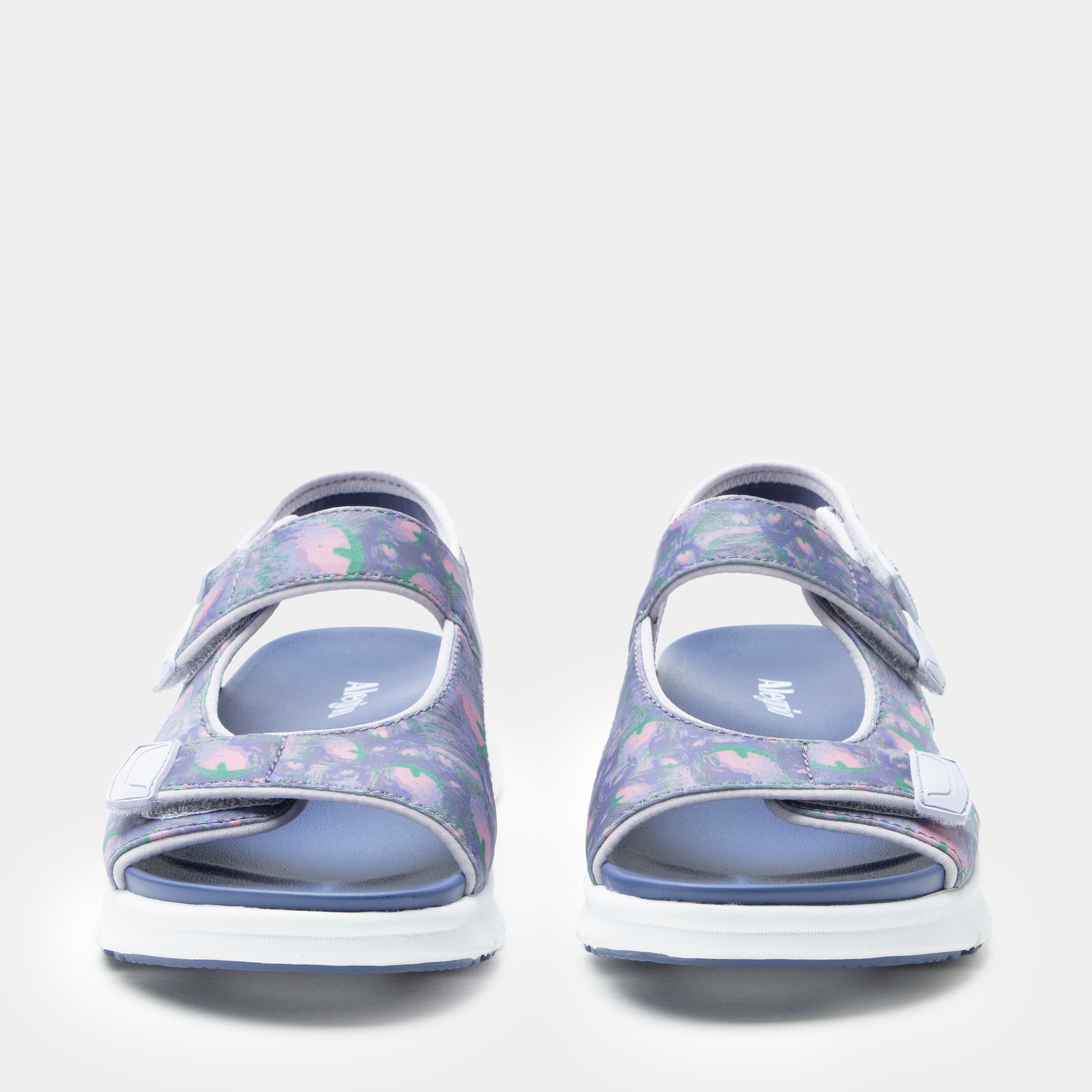 Pair of floral-patterned sandals on a light gray background