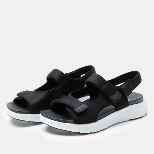 Black sandals with white soles on a light gray background