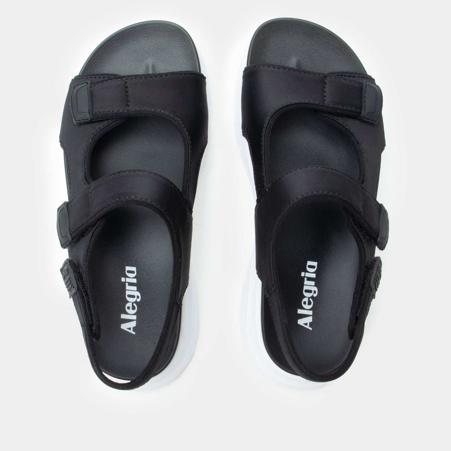 Pair of black sandals with 'Alegria' branding on a white background