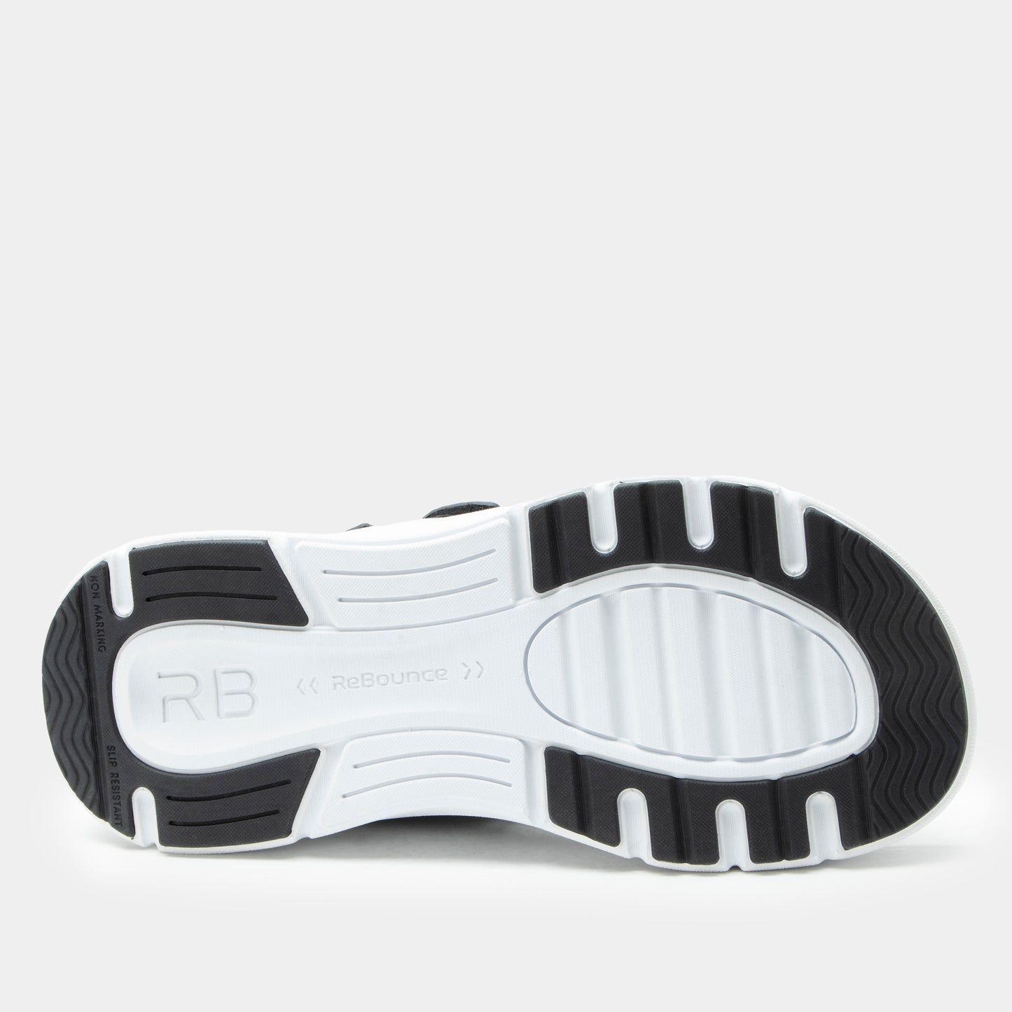 Close-up of a black and white athletic shoe sole on a light gray background